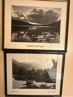 Both framed black-and-white prints hung on wall