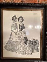 Full view of framed black and white illustration print on wall