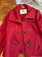 Front view of red Burberry toggle coat