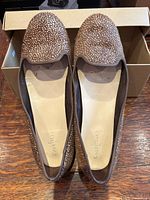 Top view of both flats showing speckled calf-hair uppers and interior size/brand markings