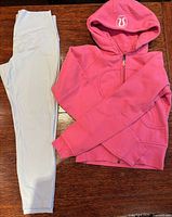 Tights and hoodie laid out side by side