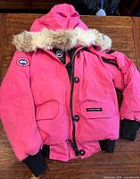 Front view of pink Canada Goose parka with fur hood