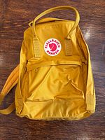 Front view of ochre Fjallraven Kanken backpack