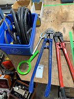 Two bolt cutters, circular magnet, coiled cable with locking plug