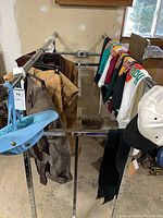 Clothing rack with hats, shirts, pants and outerwear