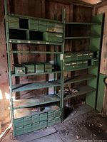 Two green metal shelving units with integrated drawers and bins