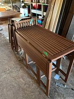 folded table with four folded chairs beside it