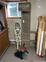 Full lot overview showing toboggan, snowshoes, paddles, dumbbells, balls