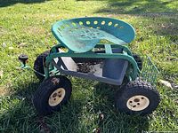 Full view of garden dolly showing seat, frame, tires, basket and tray