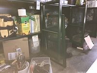 Open cabinet showing tool pouch, fertilizer, bins with tools and cords