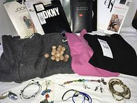 Full lot showing hosiery packages, knit tops, jewelry pieces and cedar balls