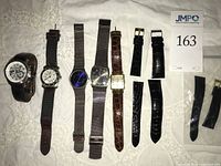 Group shot showing five watches and extra bands