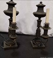 Pair of metal table lamps front view showing overall design and patina
