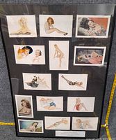 front view of framed postcard display showing artwork and measuring tape