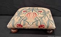 Top view showing floral tapestry upholstery and nailhead trim
