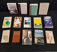 All 14 books laid out in three rows