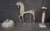 all three items grouped: metal horse, stoneware dome lid, candle holder