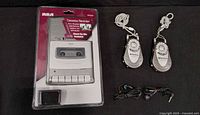 Front view of sealed RCA cassette recorder package, two Vextra radios and two earbuds