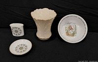 Four china pieces: Lenox vase, Wedgwood bowl, Royal Worcester pot and saucer