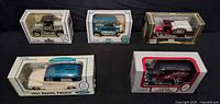 Front view of all five boxed Agway die-cast coin bank vehicles
