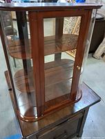 Front view of wall curio cabinet with glass door and sides