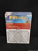Front view of four stacked Filtrete 1000 Allergen Defense filters showing size 20x25x1