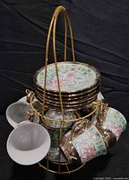 Set assembled on stand showing saucers and cups