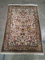 Full view of hand-tufted rug showing overall design, borders and fringe