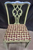 Full view of chair showing painted frame and woven seat