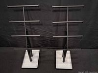 Front view of both metal T-bar jewelry stands