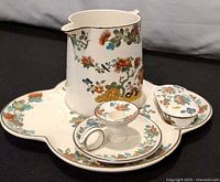 Full view of pitcher, undertray, shaving mug, and lidded soap dish showing pattern.