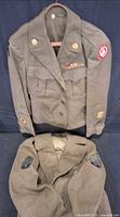 Both U.S. Army wool jackets, top hanging, bottom folded