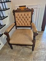 Front view of the Victorian armchair showing overall form