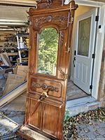 Full view of carved wood hall tree with mirror and umbrella stand