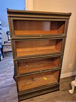 Front view showing four open sections and missing glass