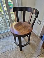 Front view of wood barstool showing seat, backrest and legs