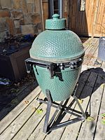Full view of Big Green Egg grill on metal stand
