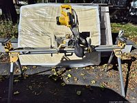 Full view of DeWalt DWS713 miter saw mounted on folding stand