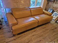 Front view of tan leather power reclining sofa