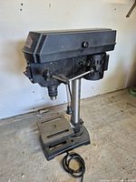 Full view of Jobmate drill press showing base, column, head, feed handle, and power cord