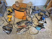 Overall view of assorted corded power tools on floor