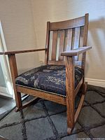 Front angled view showing overall design, oak frame, tapestry seat, wear