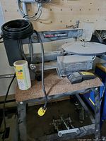 Full view of scroll saw on stand with accessories