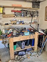 Overall view of workbench, shelving, hardware organizers, tools and accessories