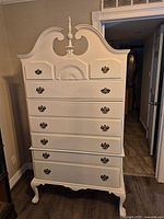 front view of white Queen Anne highboy dresser showing pediment, seven drawers, cabriole legs