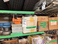 Overall shelf view showing multiple labeled boxes and bins with fasteners and fittings