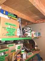 Upper shelf with Milwaukee Sawzall and assorted hardware boxes