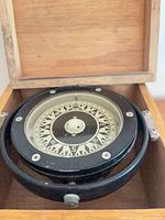 Compass inside box showing dial and gimbal