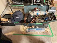 Overview of open toolbox, gas cylinder, BlueShield bag, hand tools, electrode packages