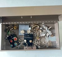 Overall view of open metal jewelry box and contents